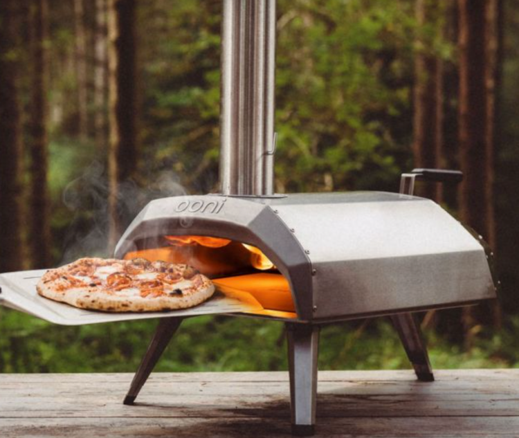 How to use an Ooni Karu 12 Multi-Fuel Pizza Oven
How to use an Ooni Karu 12 Multi-Fuel Pizza Oven will depend on what fuel type you’re using. 
You’ll need to start by following the first few steps mentioned above – remove the packaging, unfold the legs and inset the stone baking board. Also, make sure that it’s placed on a durable surface (such as stone) and has enough space, clear from anything else on all sides. 
With the Karu 12 Multi-Fuel Pizza Oven, you’ll also receive a chimney which you’ll also need to attach at this stage. 
